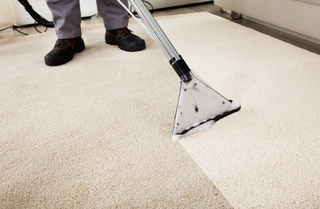 Close-up,Of,A,Person,Cleaning,Carpet,With,Vacuum,Cleaner